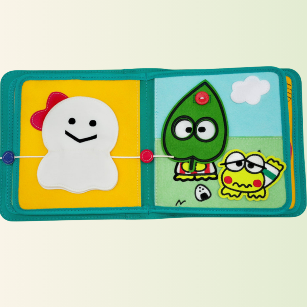 Quiet book Keroppi – cordones y tiempo meteorológico, recortado sobre fondo suave de pradera