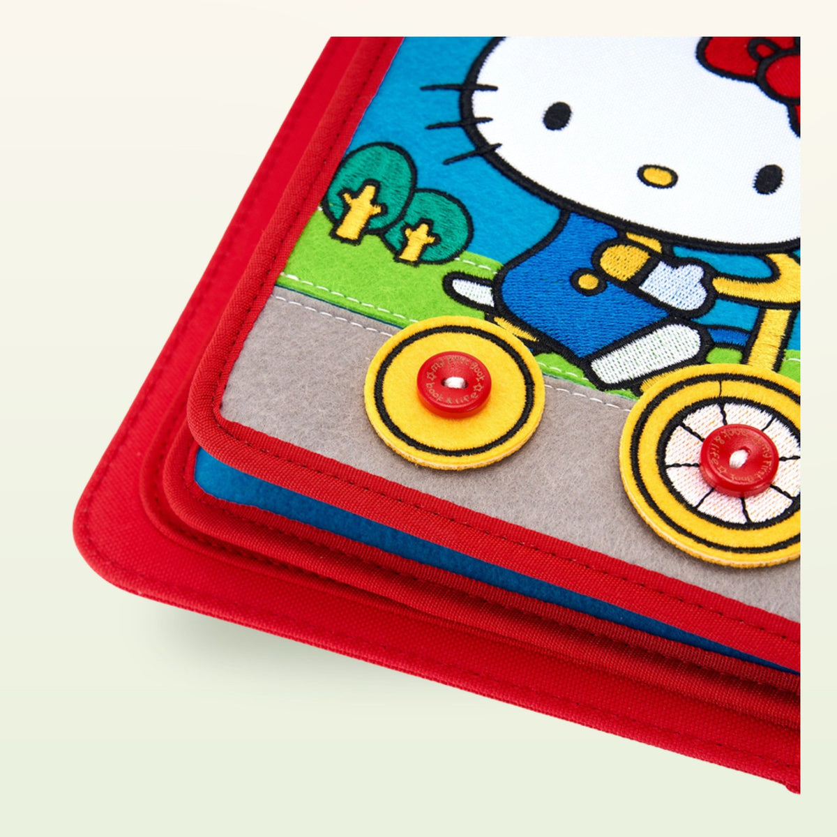 Hello Kitty quiet book bicycle detail on a soft cream background – from 3 years