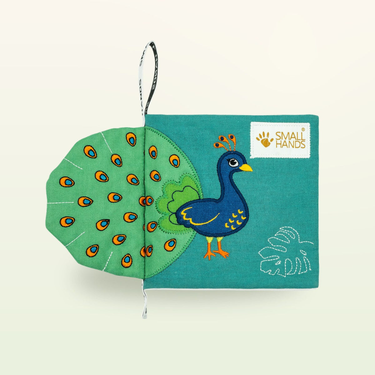 Small Hands Birds Montessori cloth book – cover with touchable peacock and green fan tail on a soft cream background – from 0 months