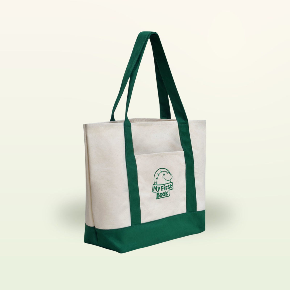 My First Book bolsa de tela – bolsa color crema con asas verdes sobre fondo suave de color crema