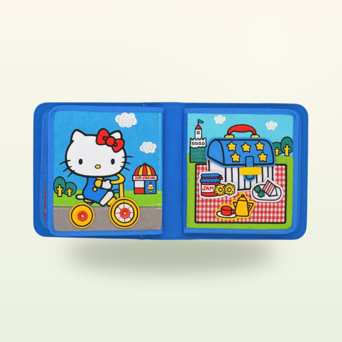 Doble página del patinete del quiet book Hello Kitty sobre fondo suave de color crema – a partir de 1 año