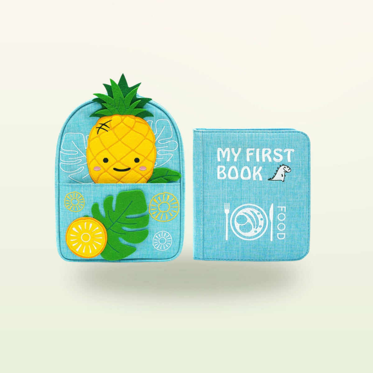 Kleine Feinschmecker Montessori Quiet Book mit passendem Ananas-Rucksack auf sanftem Creme-Hintergrund – ab 1 Jahr