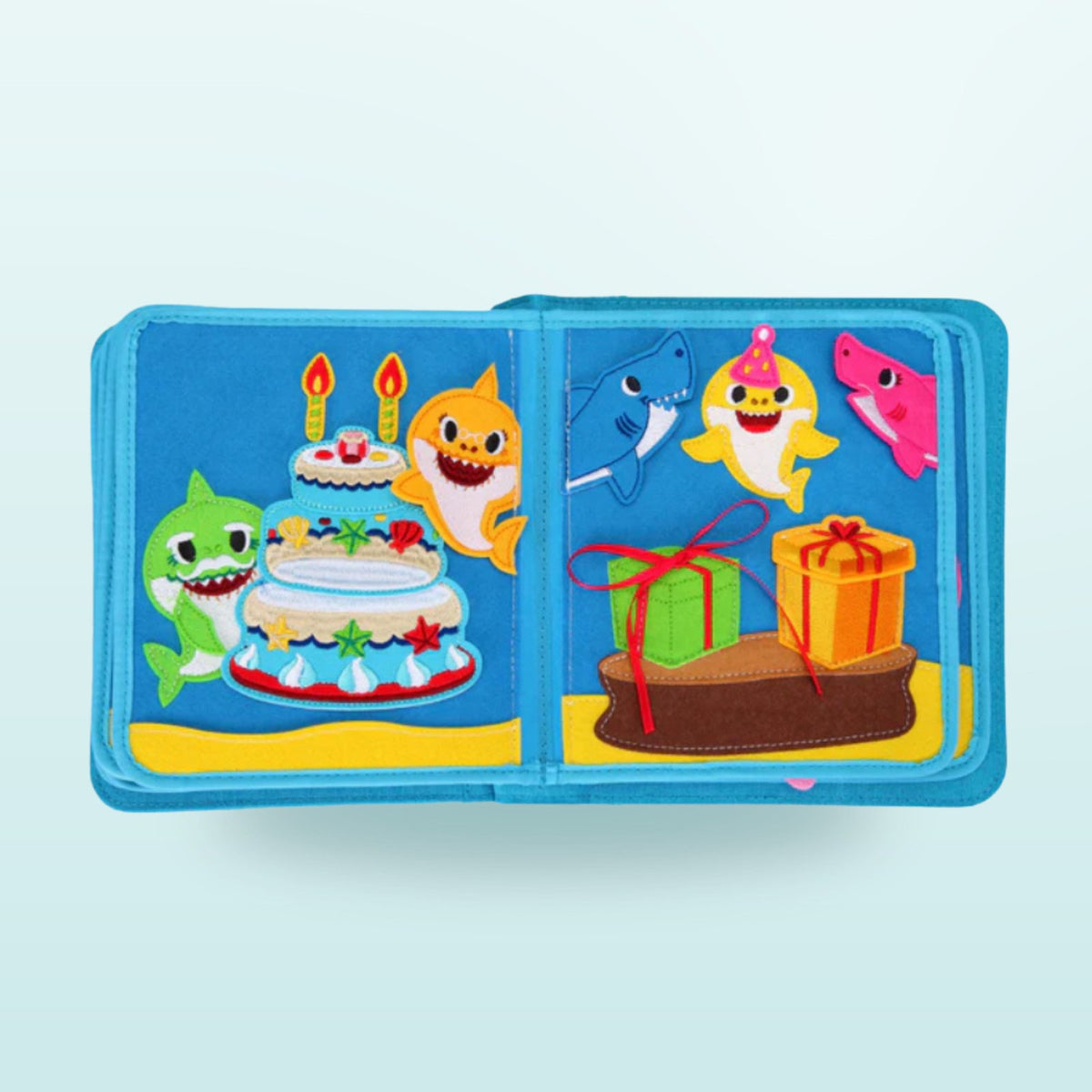 Doble página del quiet book Baby Shark con la fiesta de cumpleaños de la familia de tiburones con tarta, velas y regalos sobre fondo suave de mar – a partir de 3 años