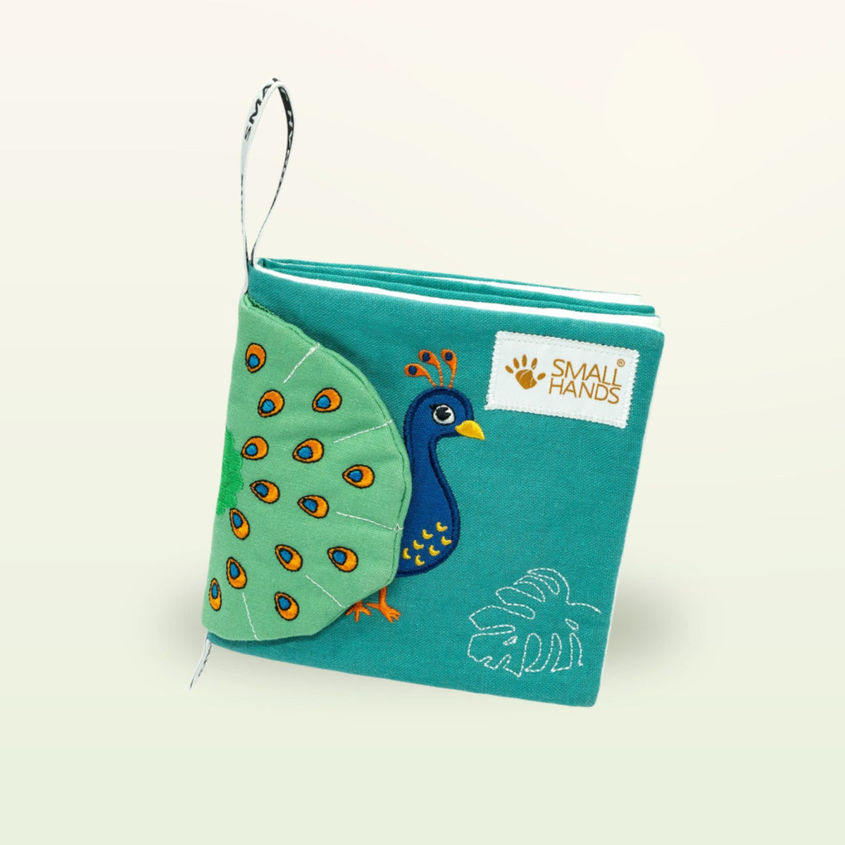 Small Hands Birds Montessori cloth book at an angle with peacock and soft fabric pages on a soft cream background – from 0 months